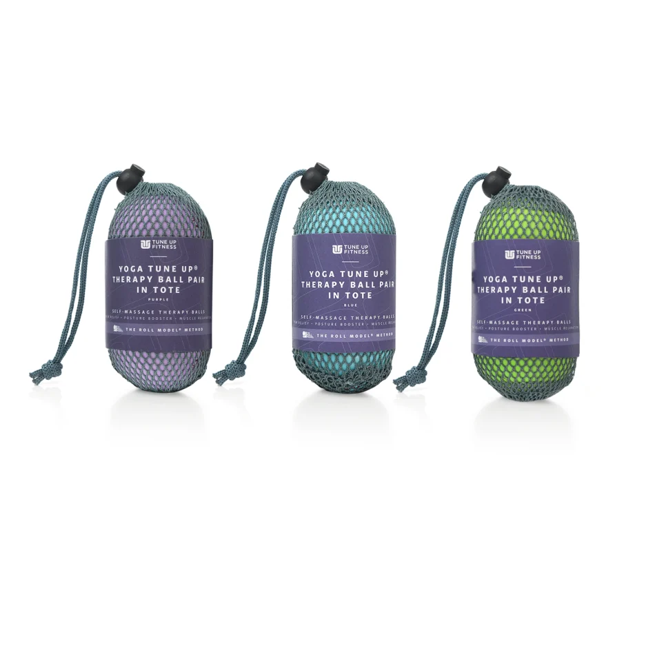Three mesh bags, each containing a pair of yoga therapy balls, are displayed.